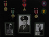 Sgt. First Class Richard Leonard Butler : Joel Tumlin contacted the 87th gallery asking about info on his great Uncle,  Sgt. First Class Richard Leonard Butler:

I am researching my Great Uncle’s time in the war.
He served in the 549th AAA AW.
From your photo gallery/info on Battery C – 
I see that he was not in this Battery.

Richard died when I was three years old. 

Here is the most accurate information I have on my great uncle.  
All of this information about Richard comes from his youngest brother, Robert O. Butler, who passed in 2006. 
Bob gave me all of Richard's medals from WWII.  
I have them along with several of his pictures in a shadow box in my home.  I have two young daughters that I want to tell as much about his service to this great country as possible.  I am aware that many of that generation do not consider themselves as heroes.  
I have a different opinion.  
This country is the greatest on earth because of their sacrifices.

I want to know all I can about my great Uncle's service.
Please post these photos and information. 
I hope to discover what Battery of the 549th that Richard did serve with,
Maybe someone who knew him, who served in the same Battery,
Or who could guide me to find more information. 

Around two years ago, I e-mailed a gentleman named Walter Clarke who told me he was in the 549th AAA HQ Battery, Medical Detachment- he added Btn Surgeons Assistant, Lt., Medical Officer.  
He gave me some information about the units activity during the Battle of the Bulge and the fight for Metz, France. 
I can not find anything more than this.

I know that there was a fire that destroyed many military records in St. Louis around 1973.  I do not know if any of Richard's records could be found elsewhere or if they exist. 

I want to honor this relative, who probably would just say he did nothing extraordinary, but just did his job.  
 
Thanks from One Proud American,
 
Joel Tumlin
Chelsea, Alabama 
35043 
jtgobama (at) hotmail.com

====

Richard Leonard Butler DOB 4-2-24 in St. Louis, MO.
He graduated from high school in 1941.  
He worked briefly at Brashear Truck Lines before he was drafted in 1941 at age 18.  

He was assigned to the 549th AAA Bn and trained at Camp Edwards, MA.  Richard was not selected to participate in the D-Day landing.  
He was billeted in "Littlecote Manor" during his stay in England.  
Later, he entered France through LeHavre and was assigned to Patton's Third Army.  He was awarded the Bronze Star for his action during the Battle of the Bulge.  

Uncle Bob said that Richard had a copy of a Christmas card with Patton’s weather prayer.  Unfortunately, the letter's whereabouts are unknown.  
 
Richard also was a part of the liberation of the Buchenwald death camp.  
Upon Germany's surrender, Richard served as an expediter in an effort to return troops to the states.  Uncle Bob said that Rich processed a full bird colonel, who was 22 years old.  This was a unusual situation where all of his superior officers were killed or wounded.  Richard worked at a embarkation port in France named the "Pall Mall" (named for cigarettes).  Richard was given a luger and holster by a surrendering German officer.  At one time, it was given to his oldest brother and my grandfather, Paul Butler.  My grandfather either sold or traded it- it hurts thinking about it today.  
Richard also served in the Korean War with his younger brother, Bob.  
My grandfather Paul was the oldest brother.  (Granddad Paul was turned down for military service due to a hearing injury he sustained as a child that impaired his hearing throughout his lifetime.  Paul did work for NASA and played a role in helping the US put a man on the moon.)

After the war, Richard worked for the railroad.  . 
Richard is buried in Jefferson Barracks National Cemetery, St. Louis, MO. 
 
Richard’s service number was 37610091.
His rank was Sgt. First Class (3 up, two down). 
Uncle Bob closed these notes with the statement that Richard,
"..in his point of view was the greatest soldier that ever wore the uniform."


To see all photos submitted from many about the 87th Infantry Division, 
or to submit yours, go to:
http://history06.smugmug.com

and 

For info on 87th Infantry Division Association:
http://www.87thinfantrydivision.com